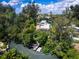 Beautiful backyard boathouse with an inviting boat dock surrounded by mature trees and a peaceful canal at 1214 Sea Plume Way, Sarasota, FL 34242