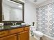 Clean bathroom with granite countertop and patterned shower curtain at 1214 Sea Plume Way, Sarasota, FL 34242