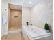 Spa-like bathroom with walk-in shower and soaking tub at 1214 Sea Plume Way, Sarasota, FL 34242