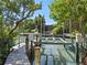 View of boat lift on a canal, surrounded by lush greenery and providing waterfront access for boating at 1214 Sea Plume Way, Sarasota, FL 34242