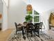Bright dining room with round wooden table and six chairs at 1214 Sea Plume Way, Sarasota, FL 34242