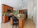 Island kitchen with granite countertops and built-in desk at 1214 Sea Plume Way, Sarasota, FL 34242