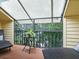 Peaceful screened balcony with comfortable lounge chairs and small table at 1214 Sea Plume Way, Sarasota, FL 34242