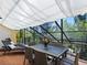 Relaxing screened patio with dining area and lounge chairs at 1214 Sea Plume Way, Sarasota, FL 34242
