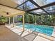 Inviting screened pool area with lounge chairs and lush landscaping at 1214 Sea Plume Way, Sarasota, FL 34242