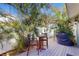 Private backyard with patio, grill, table, chairs, and lush tropical landscaping at 1220 26Th W St, Bradenton, FL 34205