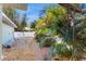 Spacious fenced backyard with rock landscaping and palm trees at 1220 26Th W St, Bradenton, FL 34205