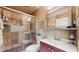Bathroom with tiled shower, vanity sink, and tiled walls and floor at 1220 26Th W St, Bradenton, FL 34205