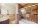 Modern bathroom with tiled shower, granite countertop vanity, and sliding glass shower door at 1220 26Th W St, Bradenton, FL 34205