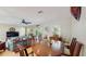 Dining area with a round wooden table and chairs next to the living area at 1220 26Th W St, Bradenton, FL 34205