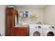 Laundry room with side-by-side Samsung washer and dryer and plenty of cabinets at 1220 26Th W St, Bradenton, FL 34205