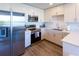 Modern kitchen featuring stainless steel appliances and light wood cabinets at 1709 N Tamiami Trl # 215, Sarasota, FL 34234