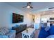 Living room with blue sofa, TV, and open kitchen at 1709 N Tamiami Trl # 215, Sarasota, FL 34234