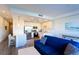 Open living room and kitchen with blue sofa and island at 1709 N Tamiami Trl # 215, Sarasota, FL 34234