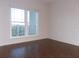 Bedroom with wood floors and large window at 210 3Rd W St # 8202, Bradenton, FL 34205