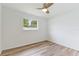 Bright bedroom with window and wood-look flooring at 2623 Suncrest Dr, Sarasota, FL 34239