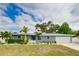 Newly renovated home with a modern facade and well-manicured lawn at 2623 Suncrest Dr, Sarasota, FL 34239