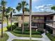 Condo building with palm trees and walkway at 2691 Sabal Springs Cir # 206, Clearwater, FL 33761