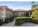 Inviting home exterior featuring a tidy walkway, manicured shrubs, and a stately double-door entrance at 322 Avenida De Paradisio, Sarasota, FL 34242