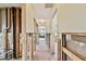 Renovation project showing exposed framing in a hallway with light colored walls and natural light at the end at 322 Avenida De Paradisio, Sarasota, FL 34242