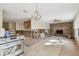 Spacious room with a brick fireplace and exposed kitchen; renovation in progress, full of potential at 322 Avenida De Paradisio, Sarasota, FL 34242