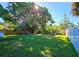 Large backyard with grassy area and mature tree at 3310 Lexington St, Sarasota, FL 34231