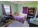 Bedroom with purple bedding and built-in shelving at 3310 Lexington St, Sarasota, FL 34231