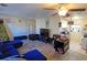 Living room with blue sectional and open kitchen view at 3310 Lexington St, Sarasota, FL 34231