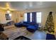 Living area with blue sectional sofa and Christmas tree at 3310 Lexington St, Sarasota, FL 34231