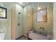 Modern bathroom with green tile, a walk-in shower, and a concrete sink at 3348 Old Oak Dr, Sarasota, FL 34239