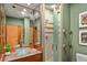Stylish bathroom featuring a glass bowl sink, frosted glass shower, and green hues at 3348 Old Oak Dr, Sarasota, FL 34239