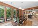 Dining area with modern table and chairs, wood-paneled walls, and natural light at 3348 Old Oak Dr, Sarasota, FL 34239