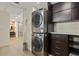 Laundry room with a stacked washer and dryer and ample cabinet space at 3348 Old Oak Dr, Sarasota, FL 34239