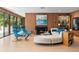 Living area with wood-paneled walls, fireplace, and plush white sectional sofa at 3348 Old Oak Dr, Sarasota, FL 34239