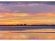Stunning ocean view with a colorful sunset reflecting on the water at 3348 Old Oak Dr, Sarasota, FL 34239
