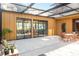 Covered patio with outdoor seating, gym access, and lush greenery at 3348 Old Oak Dr, Sarasota, FL 34239