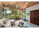 Bright sunroom with large windows, comfortable seating, and scenic views at 3348 Old Oak Dr, Sarasota, FL 34239