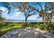 Enjoy the beautiful waterfront view from the patio with comfortable seating and beautiful trees at 3350 Old Oak Dr, Sarasota, FL 34239