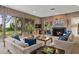 Stylish living room with wood paneling, fireplace, and large windows at 3350 Old Oak Dr, Sarasota, FL 34239