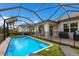 Enclosed pool area with artificial turf and lounge chairs at 3409 Anchor Bay Trl, Bradenton, FL 34211