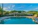 Inviting pool with spa and serene water views at 3606 Fair Oaks Pl, Longboat Key, FL 34228