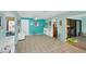 Bright office or den with teal walls, tiled floors, and built-in shelving at 3711 Glen Oaks Manor Dr, Sarasota, FL 34232