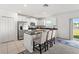 Kitchen featuring white cabinets, stainless steel appliances, granite counters, and a view of the backyard at 4016 86Th E St, Palmetto, FL 34221