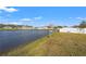 Pond with grassy shore and residential houses at 4016 86Th E St, Palmetto, FL 34221