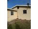 Backyard view of a single-story home featuring some landscaping and a downspout at 406 Laurel E Rd, Nokomis, FL 34275