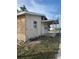 Front view of a single-story house with covered porch and some boarded windows at 406 Laurel E Rd, Nokomis, FL 34275