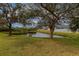 Peaceful backyard setting with pond and lush greenery at 4167 Day Bridge Pl, Ellenton, FL 34222