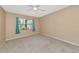 Bedroom with neutral walls, carpet flooring, and ceiling fan at 425 30Th W Ave # C107, Bradenton, FL 34205