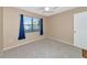 Bright bedroom with neutral walls, carpet, and window coverings at 425 30Th W Ave # C107, Bradenton, FL 34205