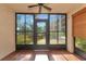Spacious screened porch with tile flooring and access to backyard at 425 30Th W Ave # C107, Bradenton, FL 34205